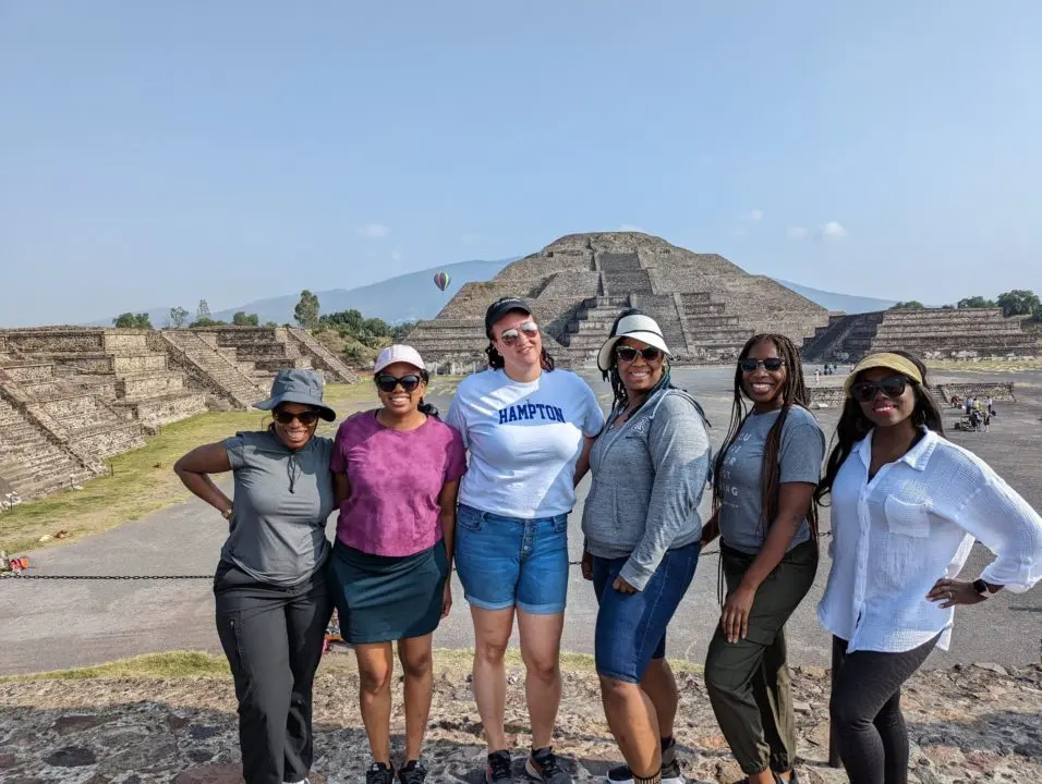 A picture of a group of Black women travelers in front of Teotihuacan outside of Mexico city